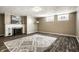 Finished basement with a fireplace, modern art, and a decorative area rug at 2615 Kessler Blvd E Dr, Indianapolis, IN 46220