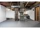 Unfinished basement with utilities in view and painted walls and floors at 2615 Kessler Blvd E Dr, Indianapolis, IN 46220