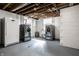 Basement laundry area with high-end washer/dryer units and a stand-up freezer at 2615 Kessler Blvd E Dr, Indianapolis, IN 46220