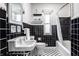 Classic black and white bathroom with vintage fixtures, patterned tile floors, and natural light at 2615 Kessler Blvd E Dr, Indianapolis, IN 46220