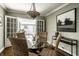 Charming dining area features wood floors and views through French doors to the backyard at 2615 Kessler Blvd E Dr, Indianapolis, IN 46220