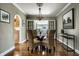 Dining room boasts wood floors, french doors, modern light fixture and adjacent kitchen at 2615 Kessler Blvd E Dr, Indianapolis, IN 46220