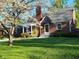 Charming brick home with well-manicured lawn and flowering tree, exuding classic curb appeal and inviting ambiance at 2615 Kessler Blvd E Dr, Indianapolis, IN 46220