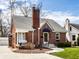 Charming brick home featuring a classic design, a welcoming porch swing, and well-maintained landscaping at 2615 Kessler Blvd E Dr, Indianapolis, IN 46220