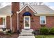 Close-up of a brick home's entrance showcasing the architectural details and manicured landscaping at 2615 Kessler Blvd E Dr, Indianapolis, IN 46220