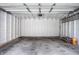 Spacious garage featuring white walls, concrete floor and room for vehicles and storage at 2615 Kessler Blvd E Dr, Indianapolis, IN 46220