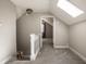 Upstairs hallway with carpet, skylight, and doorway to another room, creating a bright space at 2615 Kessler Blvd E Dr, Indianapolis, IN 46220
