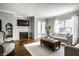 Cozy living room with a fireplace, hardwood floors, and comfortable seating at 2615 Kessler Blvd E Dr, Indianapolis, IN 46220