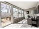 Inviting sunroom with ample natural light, outdoor access, and comfortable seating at 2615 Kessler Blvd E Dr, Indianapolis, IN 46220