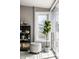Bright sunroom featuring a cozy ottoman, modern shelving and abundant natural light at 2615 Kessler Blvd E Dr, Indianapolis, IN 46220