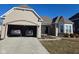 Inviting single-story home with brick detailing, attached garage, and cozy front porch entrance and manicured lawn at 2625 Kilgobbin Cres, Brownsburg, IN 46112