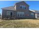 Back exterior of house featuring large windows, a sliding glass door and an open deck at 2625 Kilgobbin Cres, Brownsburg, IN 46112