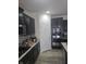 Modern kitchen featuring dark cabinetry, stainless steel appliances, granite countertops, and stylish backsplash at 2625 Kilgobbin Cres, Brownsburg, IN 46112