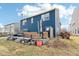 View of the backyard with a deck featuring outdoor seating, set against a backdrop of a blue home exterior at 3132 W Meadowbend Dr, Monrovia, IN 46157