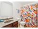 Bright bathroom featuring a floral shower curtain and a granite-look vanity for a touch of style at 3132 W Meadowbend Dr, Monrovia, IN 46157