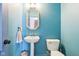 Charming powder room with a pedestal sink, decorative mirror, and turquoise-painted walls at 3132 W Meadowbend Dr, Monrovia, IN 46157