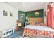 Inviting bedroom features a cozy bed, stylish green accent wall, and whimsical decor, creating a unique space at 3132 W Meadowbend Dr, Monrovia, IN 46157