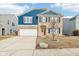 Inviting two-story home featuring brick and blue siding, a two-car garage, and a neatly landscaped front yard at 3132 W Meadowbend Dr, Monrovia, IN 46157