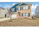 Inviting two-story home featuring brick and blue siding, a two-car garage, and a neatly landscaped front yard at 3132 W Meadowbend Dr, Monrovia, IN 46157