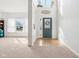 Bright and airy foyer with tile entry, carpeted living space, high ceilings, and a large window at 3132 W Meadowbend Dr, Monrovia, IN 46157