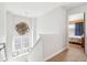 Upstairs hallway bathed in natural light, featuring a decorative accent and view into a bedroom at 3132 W Meadowbend Dr, Monrovia, IN 46157