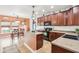 Modern kitchen showcasing an island, dark cabinets, black appliances, and an adjacent dining area at 3132 W Meadowbend Dr, Monrovia, IN 46157