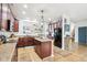 Open concept kitchen with dark wood cabinets, center island, and modern appliances, ideal for cooking and entertaining at 3132 W Meadowbend Dr, Monrovia, IN 46157