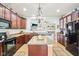 Well-equipped kitchen with ample cabinetry, center island, and modern appliances, designed for culinary enthusiasts at 3132 W Meadowbend Dr, Monrovia, IN 46157