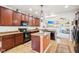 Modern kitchen with dark cabinets, an island, and sleek appliances, perfect for cooking and socializing at 3132 W Meadowbend Dr, Monrovia, IN 46157