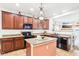 Fully equipped kitchen with a center island, dark cabinetry, and stainless steel appliances, perfect for cooking at 3132 W Meadowbend Dr, Monrovia, IN 46157