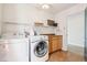 Well-equipped laundry area with modern washer and dryer, ample counter space, and convenient overhead shelving at 3132 W Meadowbend Dr, Monrovia, IN 46157