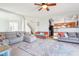 Open concept living room with ample seating, neutral tones, and natural light with views to the kitchen and entry at 3132 W Meadowbend Dr, Monrovia, IN 46157