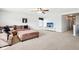 Open living area with a large sectional sofa, mounted TV, and a ceiling fan at 3132 W Meadowbend Dr, Monrovia, IN 46157
