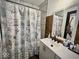 Inviting bathroom with a vanity and shower featuring shell-themed shower curtain and accents at 318 Congress Ave, Indianapolis, IN 46208