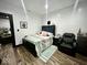 Comfortable bedroom featuring wood-look floors and neutral tones with a padded recliner at 318 Congress Ave, Indianapolis, IN 46208