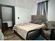 Bedroom with neutral decor, wood grain floors, and an attached closet with storage shelves at 318 Congress Ave, Indianapolis, IN 46208