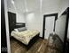 Cozy bedroom with a dark wood framed bed, light floral bedding, and wood grain floors at 318 Congress Ave, Indianapolis, IN 46208
