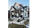 Charming two-story home featuring a covered front porch with black and white trim at 318 Congress Ave, Indianapolis, IN 46208