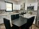 Bright kitchen with white cabinetry, mosaic backsplash, and stainless steel appliances at 318 Congress Ave, Indianapolis, IN 46208