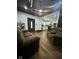 Spacious living room flowing into the kitchen boasts hardwood floors and ample seating for relaxation and entertainment at 318 Congress Ave, Indianapolis, IN 46208
