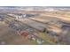 Expansive aerial view showcasing neighborhood near farmland, highlighting community, and access to major roads at 323 Norris Dr, Anderson, IN 46013