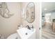 Cozy half bathroom with a unique mermaid wall decor and neutral-toned walls at 323 Norris Dr, Anderson, IN 46013