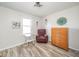 This light-filled bedroom features vinyl floors, neutral walls, and charming floral decor at 323 Norris Dr, Anderson, IN 46013