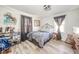 Charming bedroom with wood-look floors, decorative shelving, and natural light from two windows at 323 Norris Dr, Anderson, IN 46013