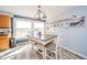 Bright dining area with wood table, chairs, and natural light from nearby windows at 323 Norris Dr, Anderson, IN 46013