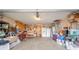 Spacious garage interior with ample storage, shelving, and workspace for projects and parking at 323 Norris Dr, Anderson, IN 46013