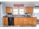 Spacious kitchen sink with wooden cabinetry, offering a delightful view through the window at 323 Norris Dr, Anderson, IN 46013