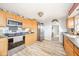 Well-lit kitchen showcasing stainless steel appliances and light-colored wooden cabinetry at 323 Norris Dr, Anderson, IN 46013
