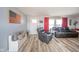 Open concept living room with wood floors and gray furniture with views to the front door at 323 Norris Dr, Anderson, IN 46013
