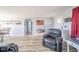 Open concept living room with wood floors and gray furniture with views to the dining area at 323 Norris Dr, Anderson, IN 46013